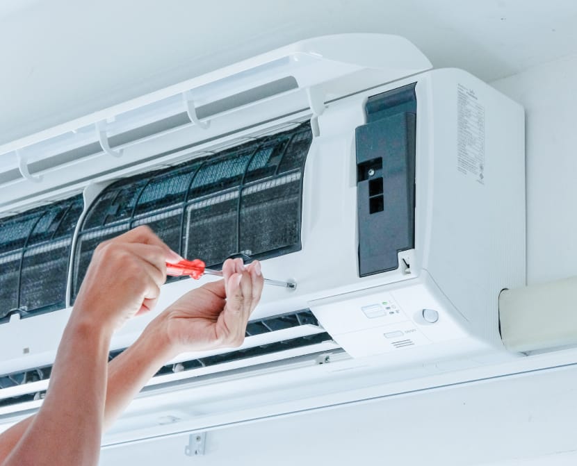 Technicien professionnel effectuant l'entretien d'une climatisation réversible ouverte, assurant la performance et la durabilité du système à Montauban